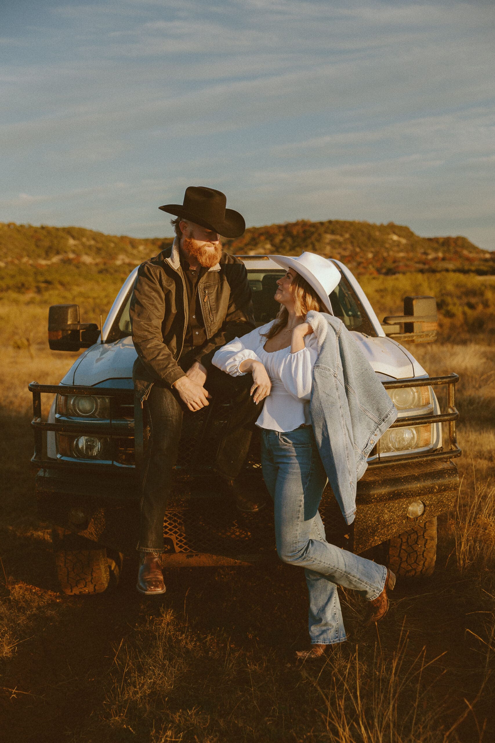Western engagement session in a gorgeous field at The Barn at Cliff Spring in Abilene, TX