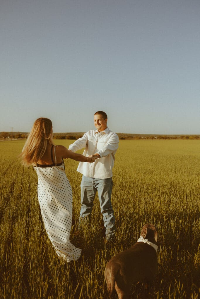 Playful couples session in a field in Ovalo, TX
