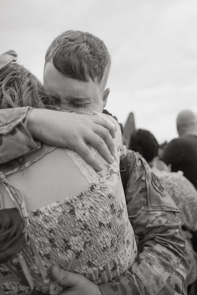 Intimate and joyful military homecoming reunion on the flight line at Dyess Air Force Base in Abilene, TX