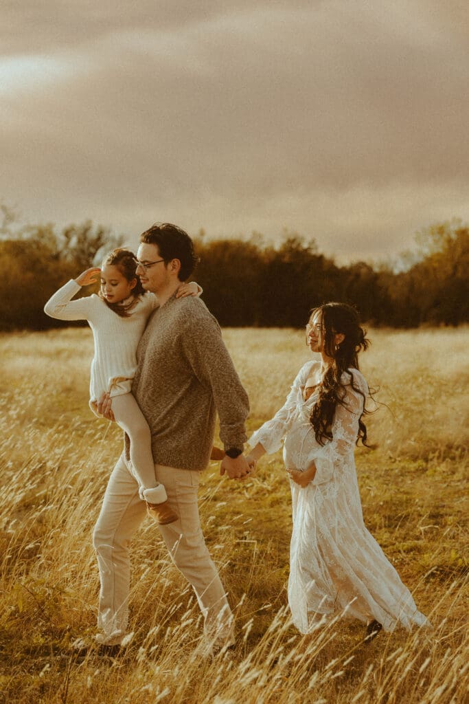 Family maternity session in a golden field in Buffalo Gap, TX
