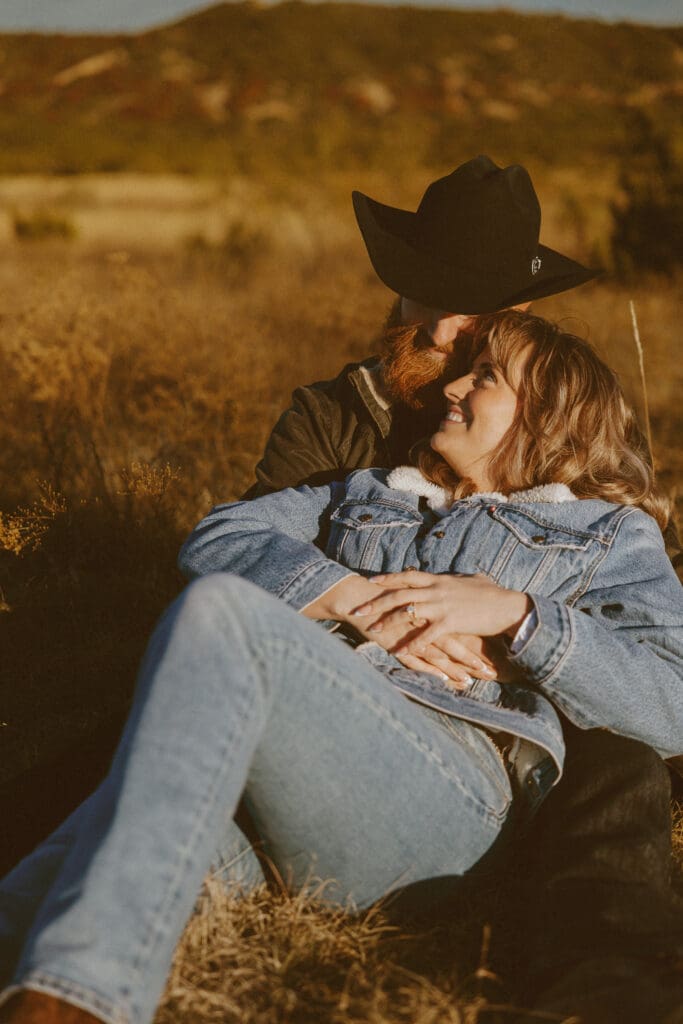 Western themed engagement session in a field at The Barn at Cliff Spring in Tuscola, TX