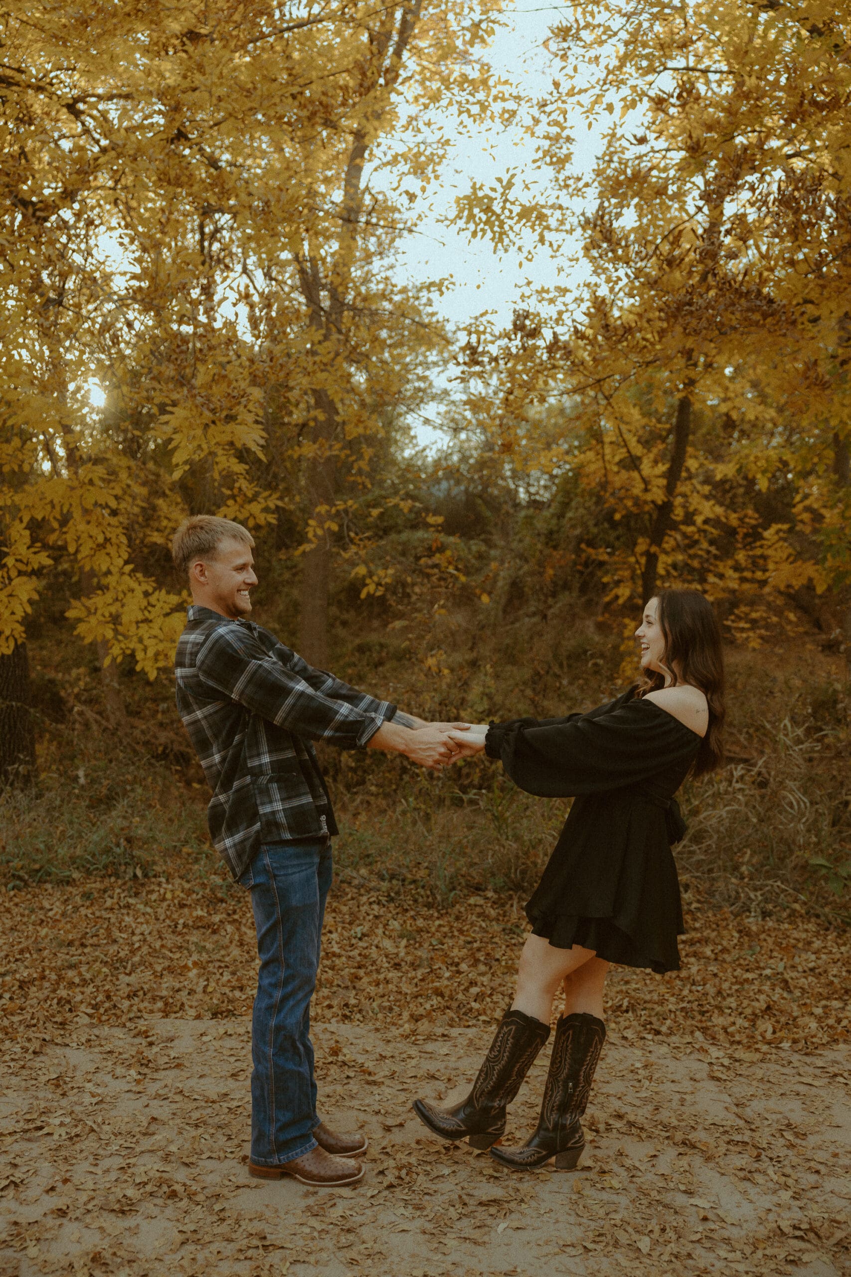 Golden, intimate fall-coded engagement session by a creek in Abilene, TX