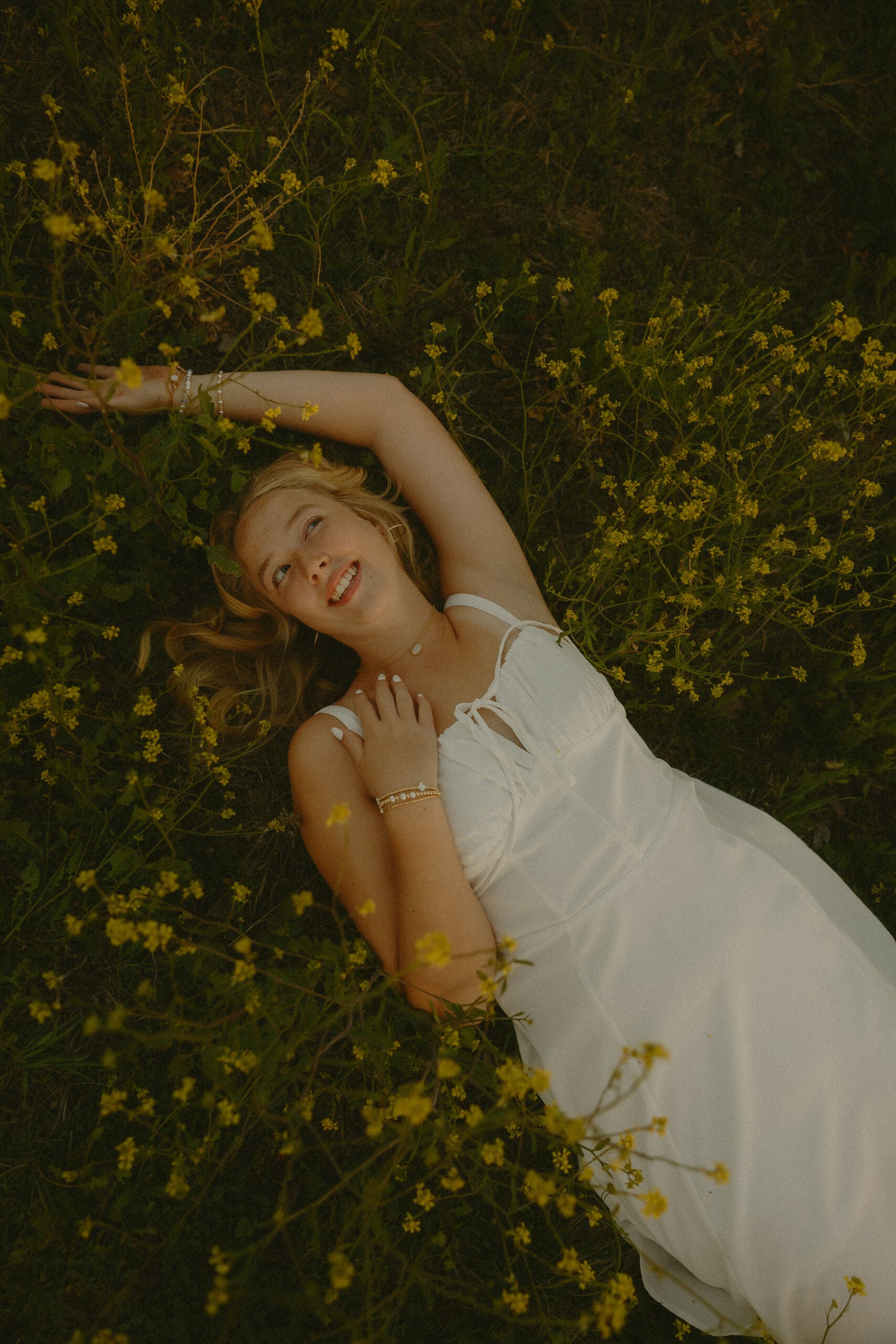 Whimsical and cinematic senior session in a field during golden hour in Abilene, TX