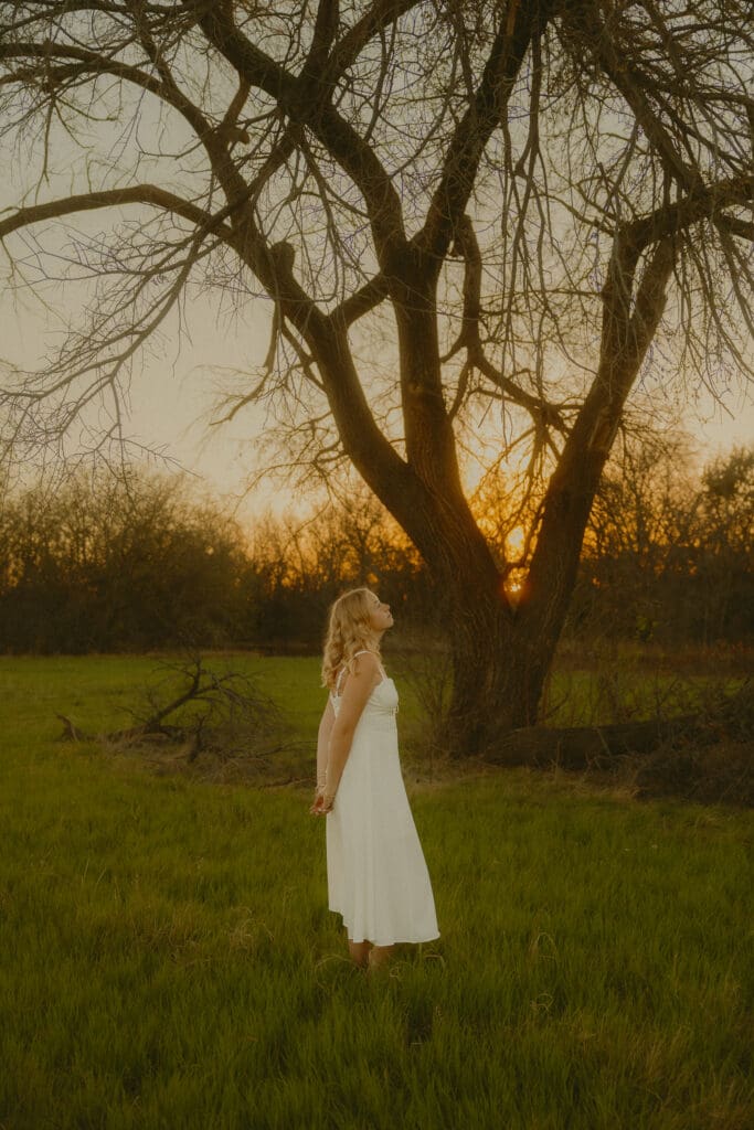 Whimsical and cinematic senior session in a field during golden hour in Abilene, TX
