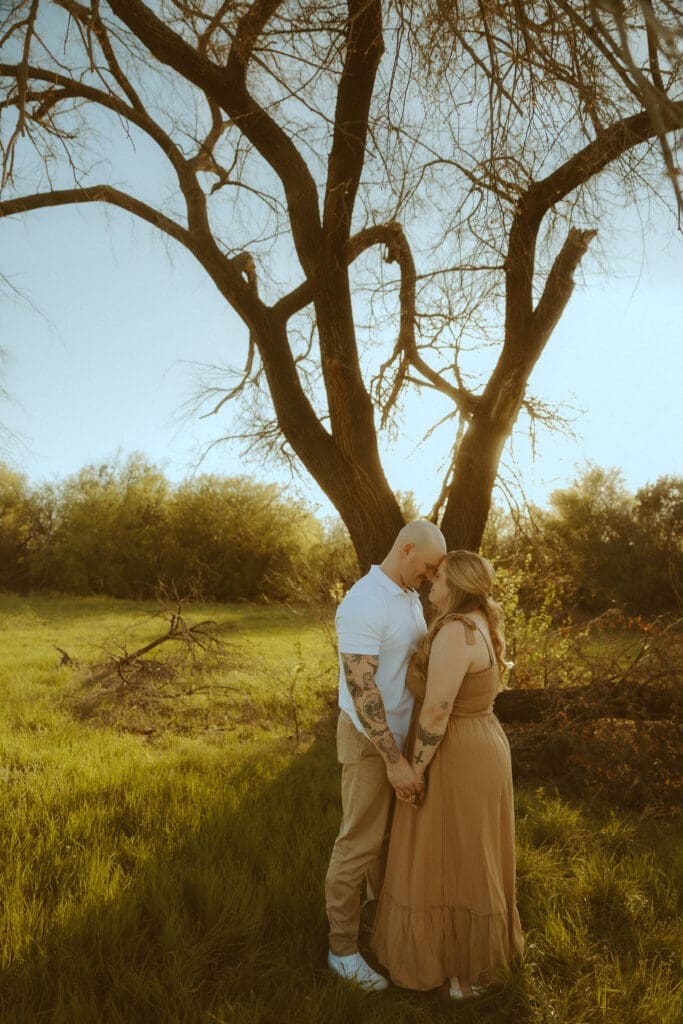 Warm and intimate couples photo underneath the dreamy, golden hour sun in a field in Abilene, TX