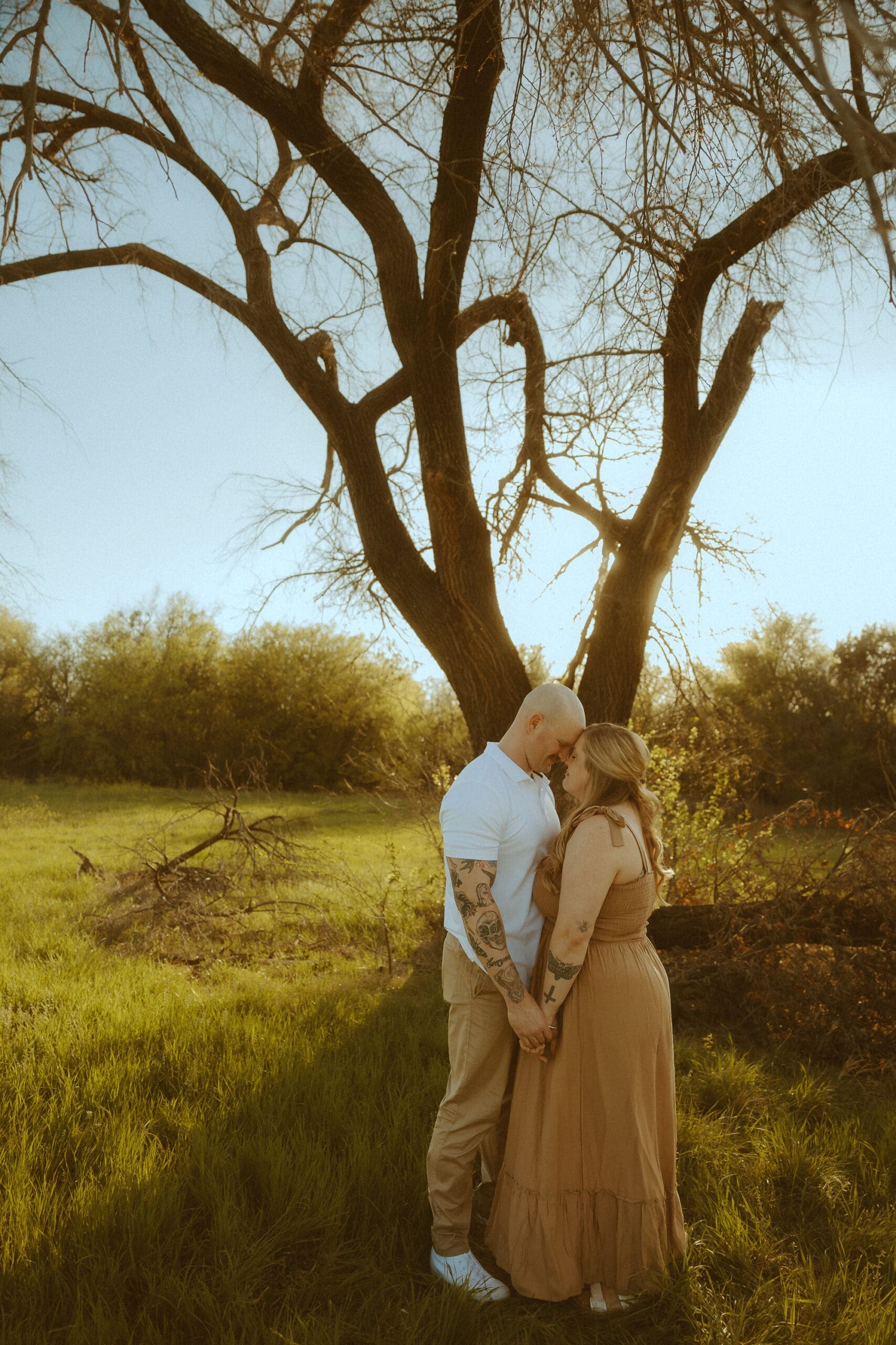 Warm and intimate couples photo underneath the dreamy, golden hour sun in a field in Abilene, TX