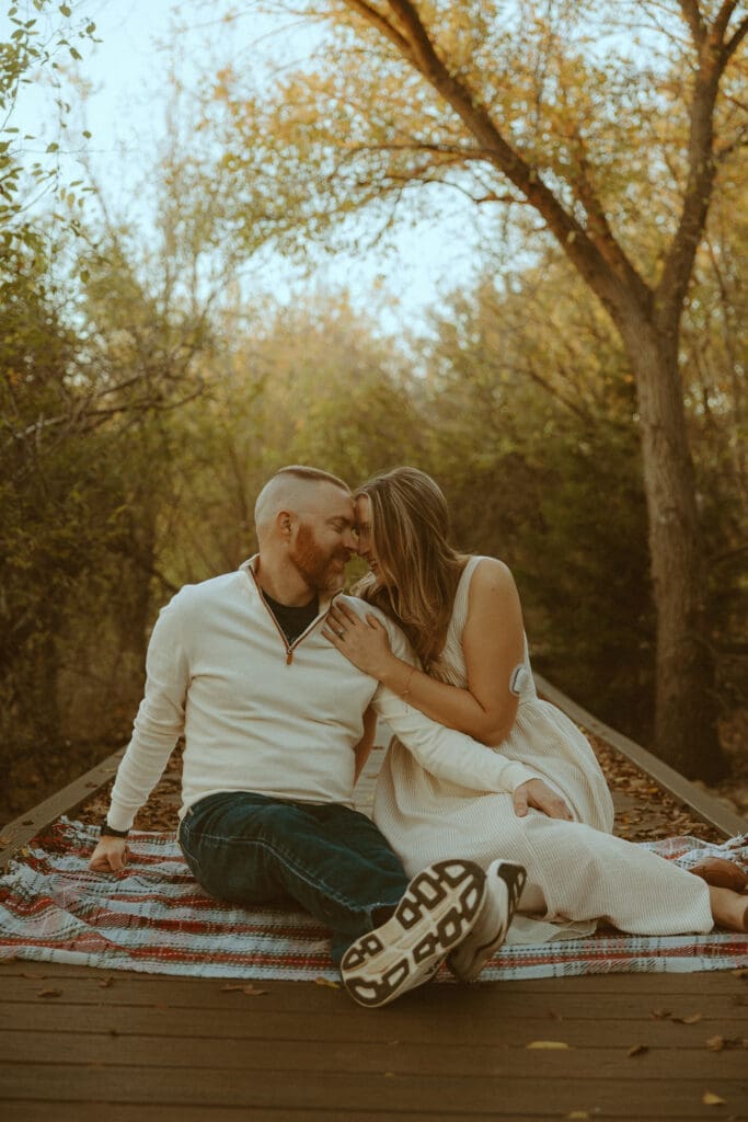 Nostalgic couples photo underneath the golden light and leaves on a bridge in Abilene, TX