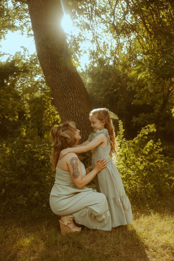 Warm nostalgic family photograph in a sunlit wooded field in Abilene during golden hour.