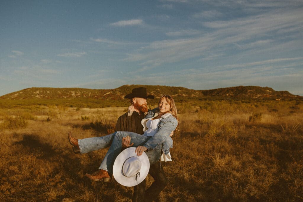 Couple enjoying a golden hour engagement session in a scenic West Texas landscape, highlighting how the right location helps tell their story.
