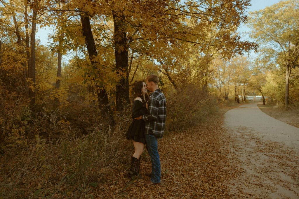 A golden hour couples session beneath the autumn trees in Abilene, Texas, capturing the meaningful connection and thoughtful planning behind every Morgan Rose Photography experience.