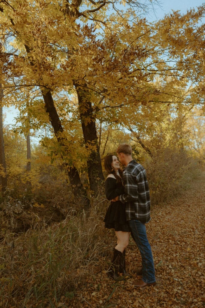 A golden hour couples session beneath the autumn trees in Abilene, Texas, capturing the meaningful connection and thoughtful planning behind every Morgan Rose Photography experience.