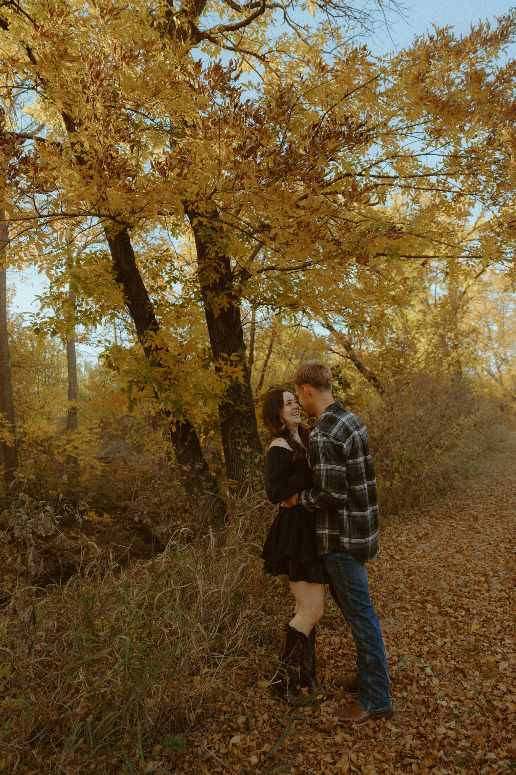 A golden hour couples session beneath the autumn trees in Abilene, Texas, capturing the meaningful connection and thoughtful planning behind every Morgan Rose Photography experience.