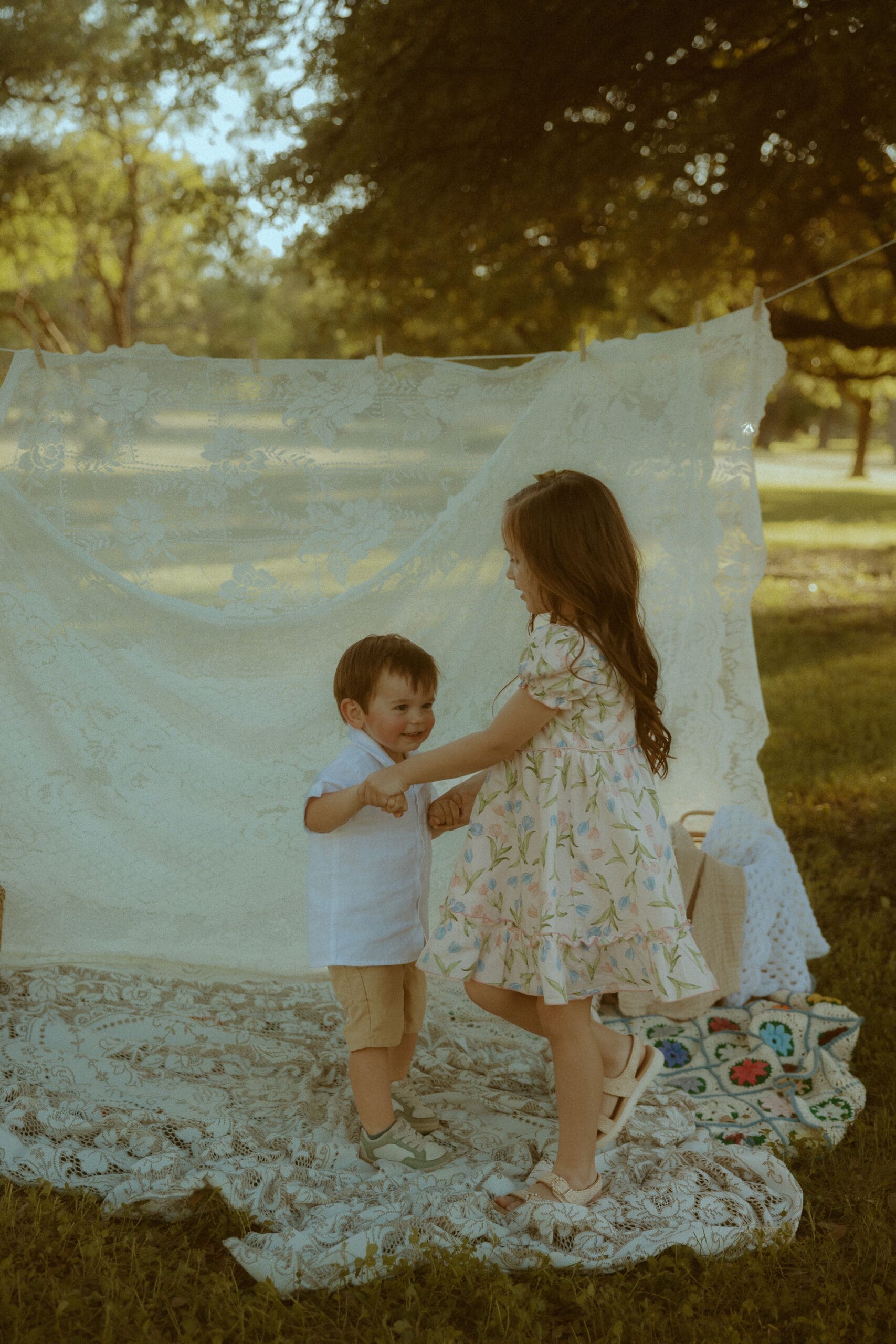 Two young siblings dancing together during a nostalgic childhood photography session in Abilene, Texas.