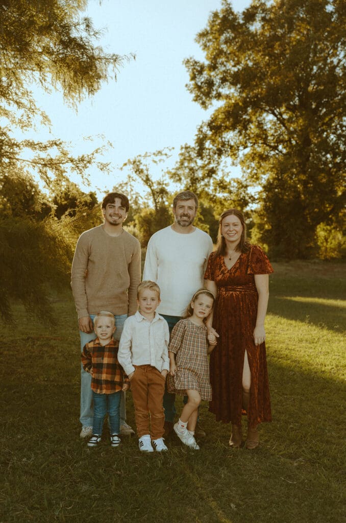 Family of six posing together during a fall family photography session in Abilene, Texas.